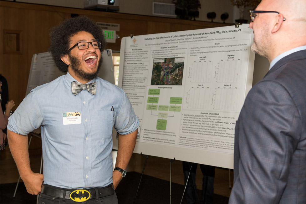 Student presents his research to an attendee