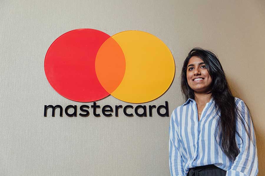 Student in front of a mastercard logo