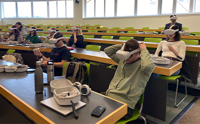 Students in law school trying out VR headsets in class