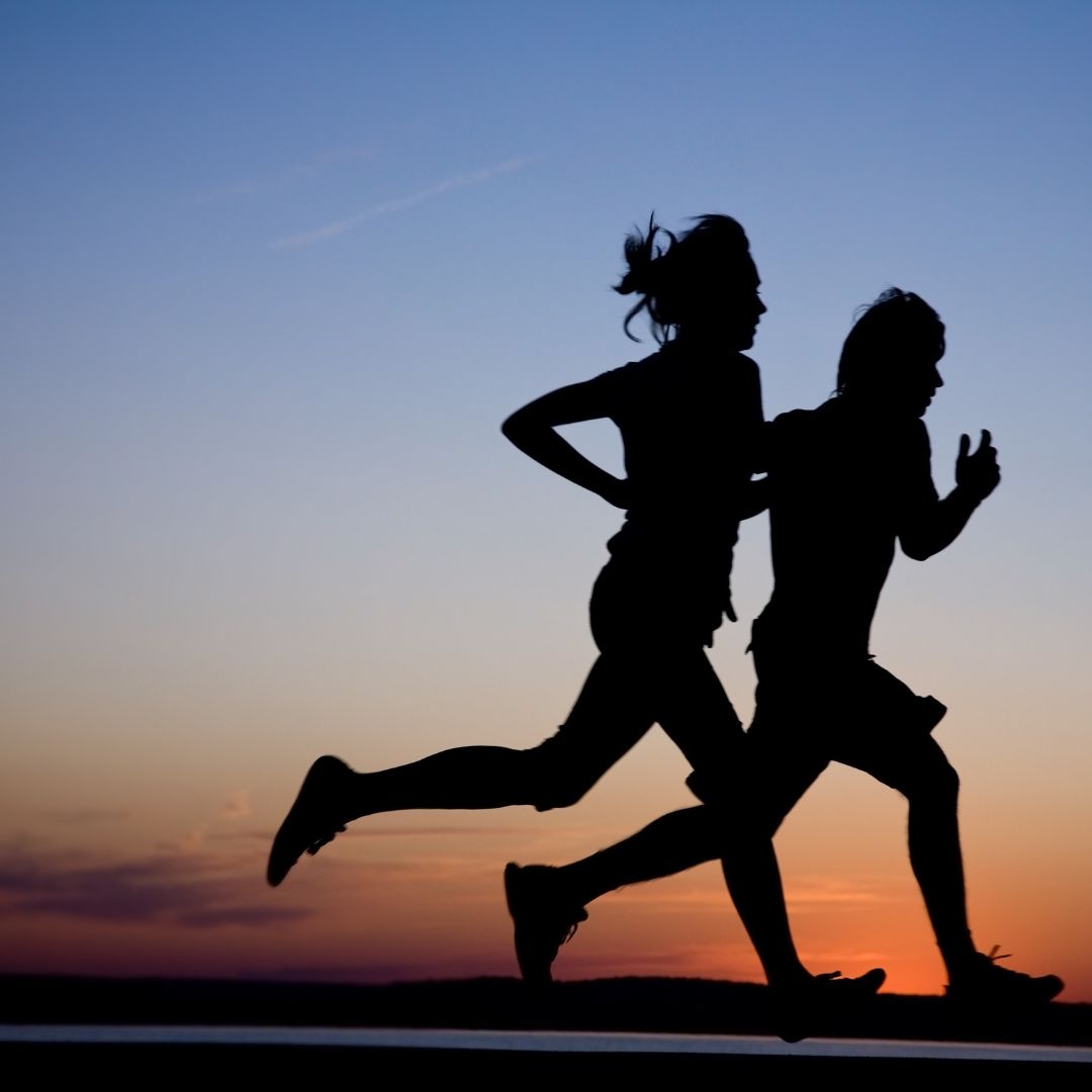 two individuals running at night