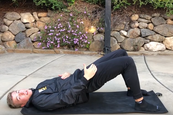 trainer performing glute bridge