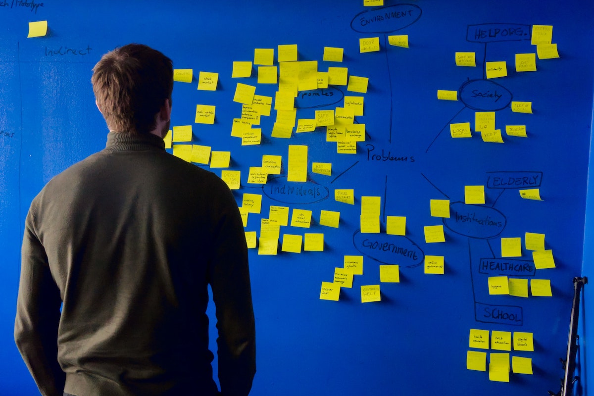 Person looking at a wall of post it notes