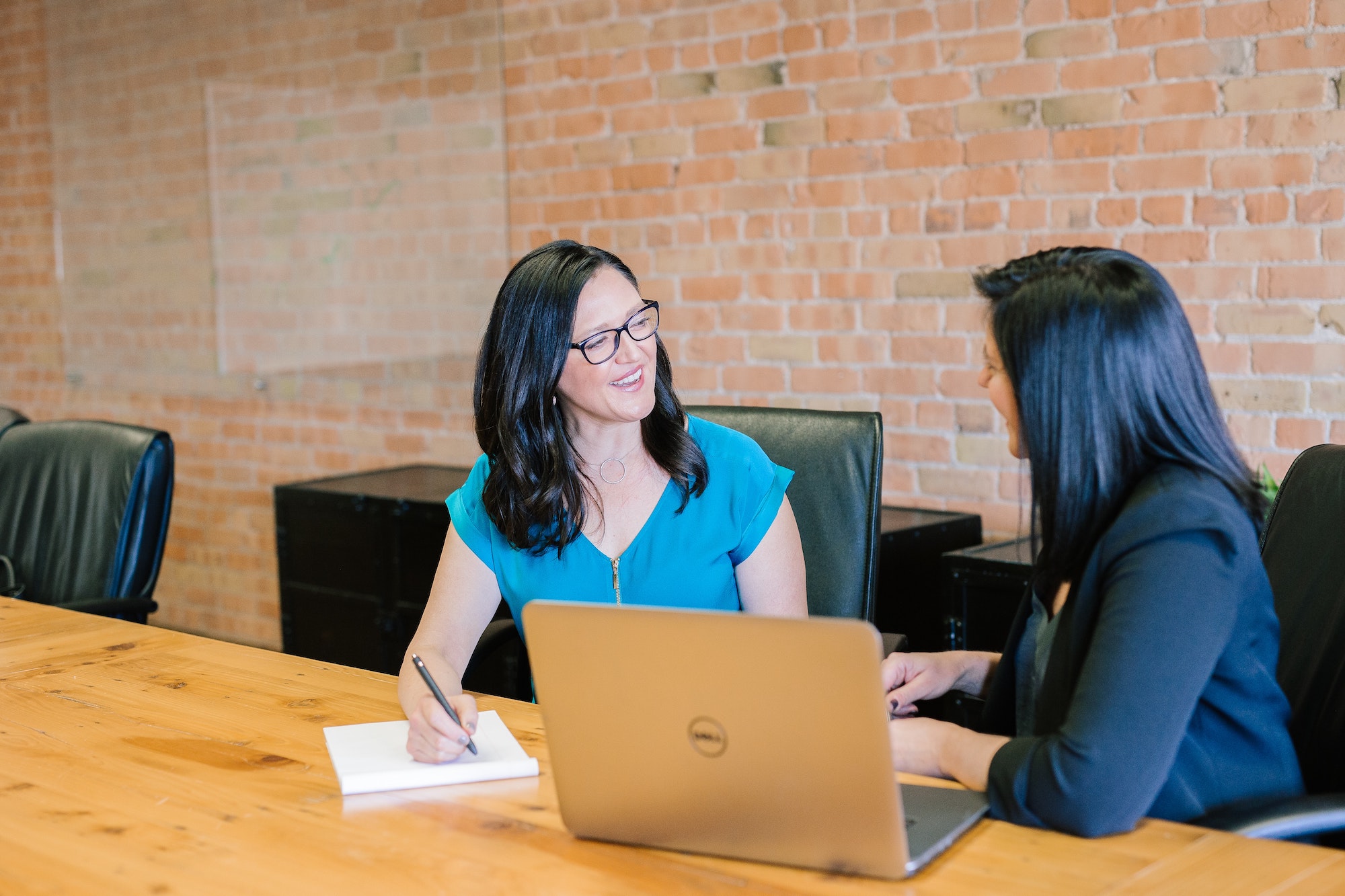 Two people in conversation at a conference table