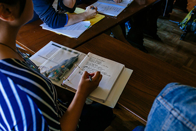 Student taking notes in class