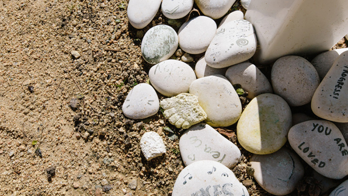 Abstract photo of rocks carefully placed outside on the dirt