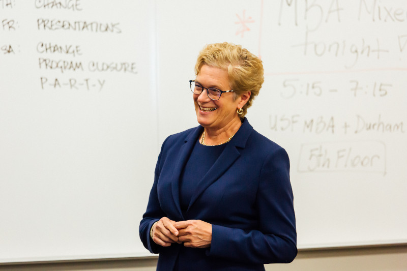 Faculty member standing in front of whiteboard