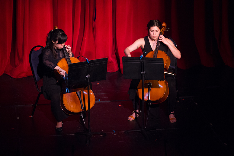 Students playing instruments on stage