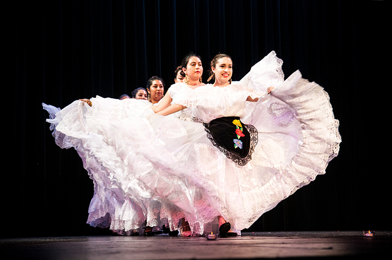 Dancers performing in white dresses