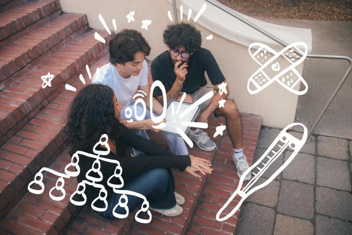 Three students looking at a tablet and engaging in app