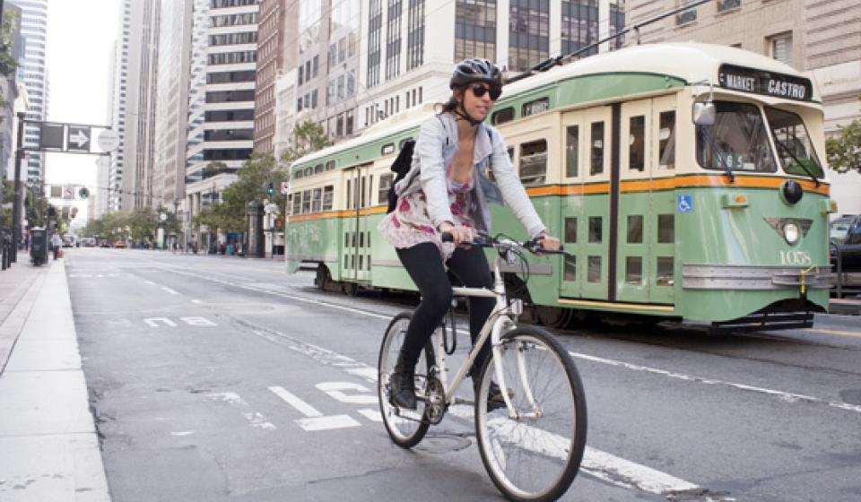 Bike rider and bus on a San Francisco street