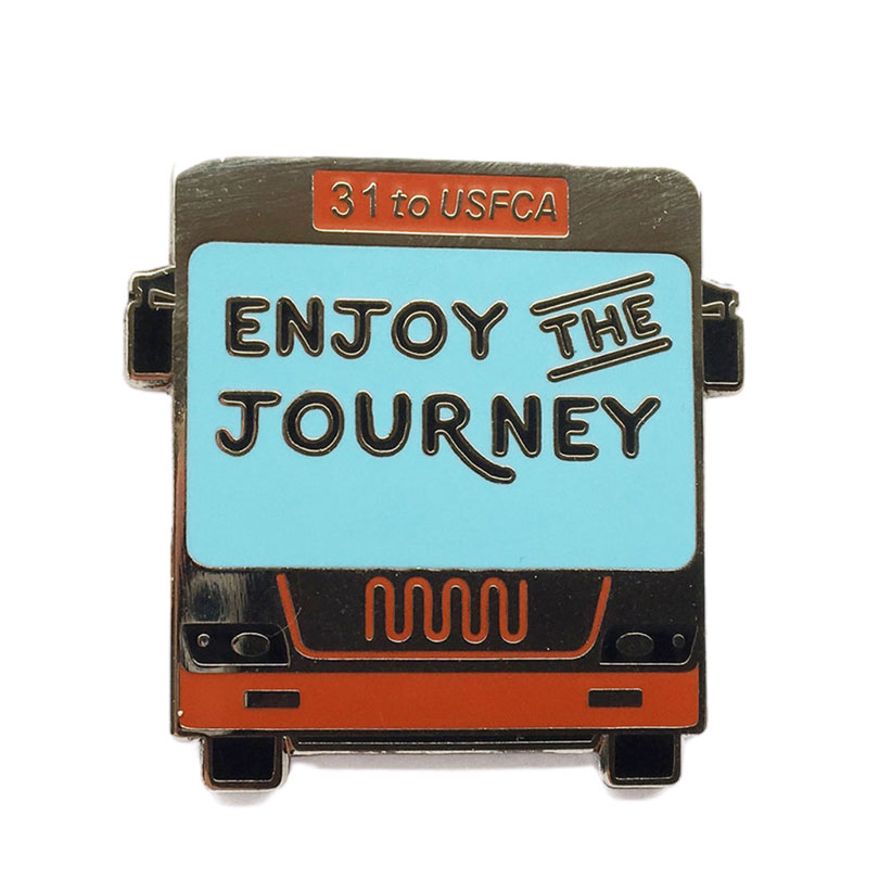 USF pin that has a bus with the words "Enjoy the Journey"