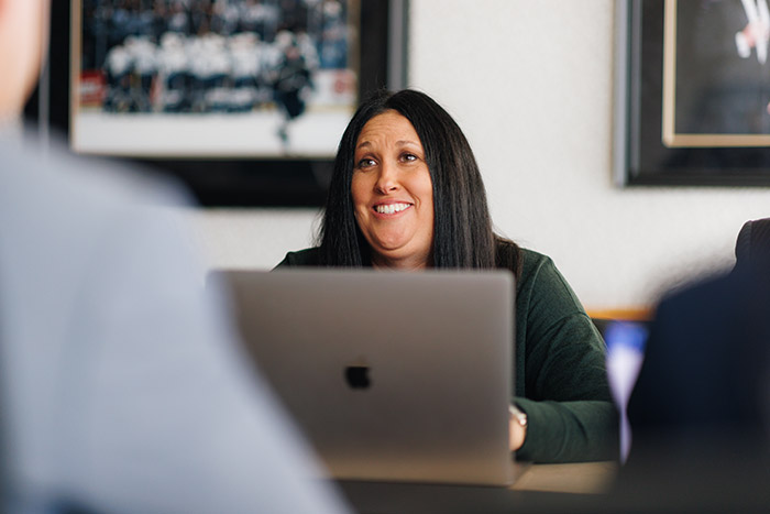 Person smiles over laptop
