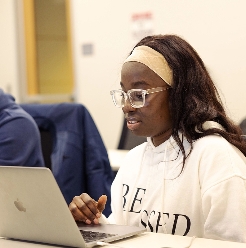 USF student working on their laptop