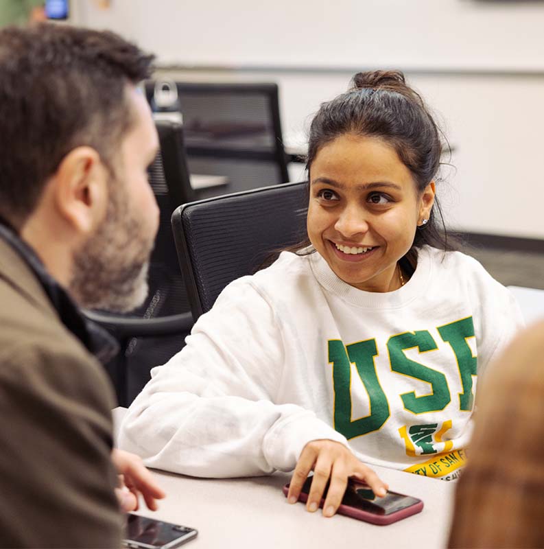 USF student chatting with a staff member
