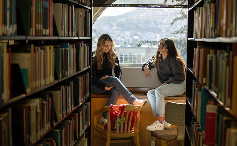 Two students sitting in the library