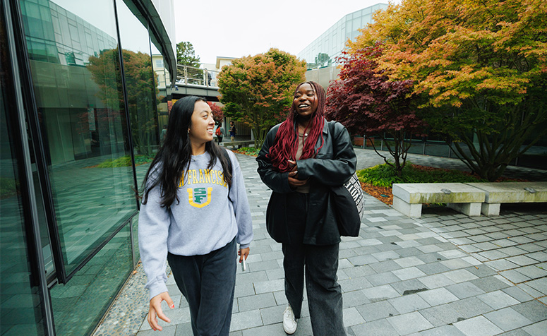 Two students walking on Lower Campus