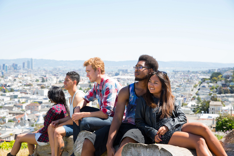 Students sitting together above the city