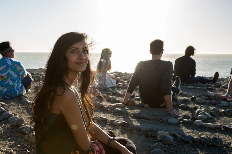 Students at beach during sunset