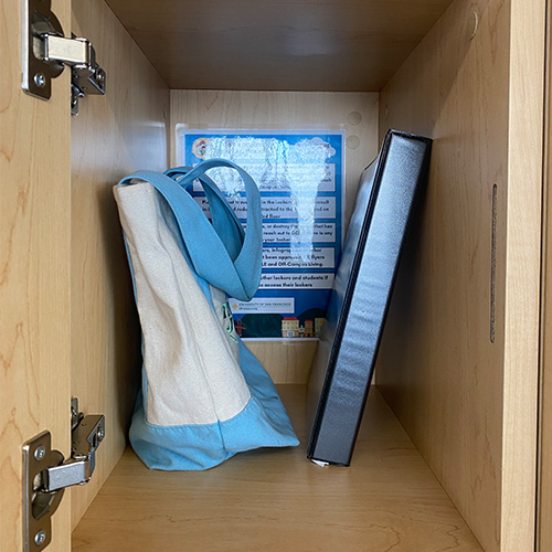 Inside of a locker with tote bag and binder