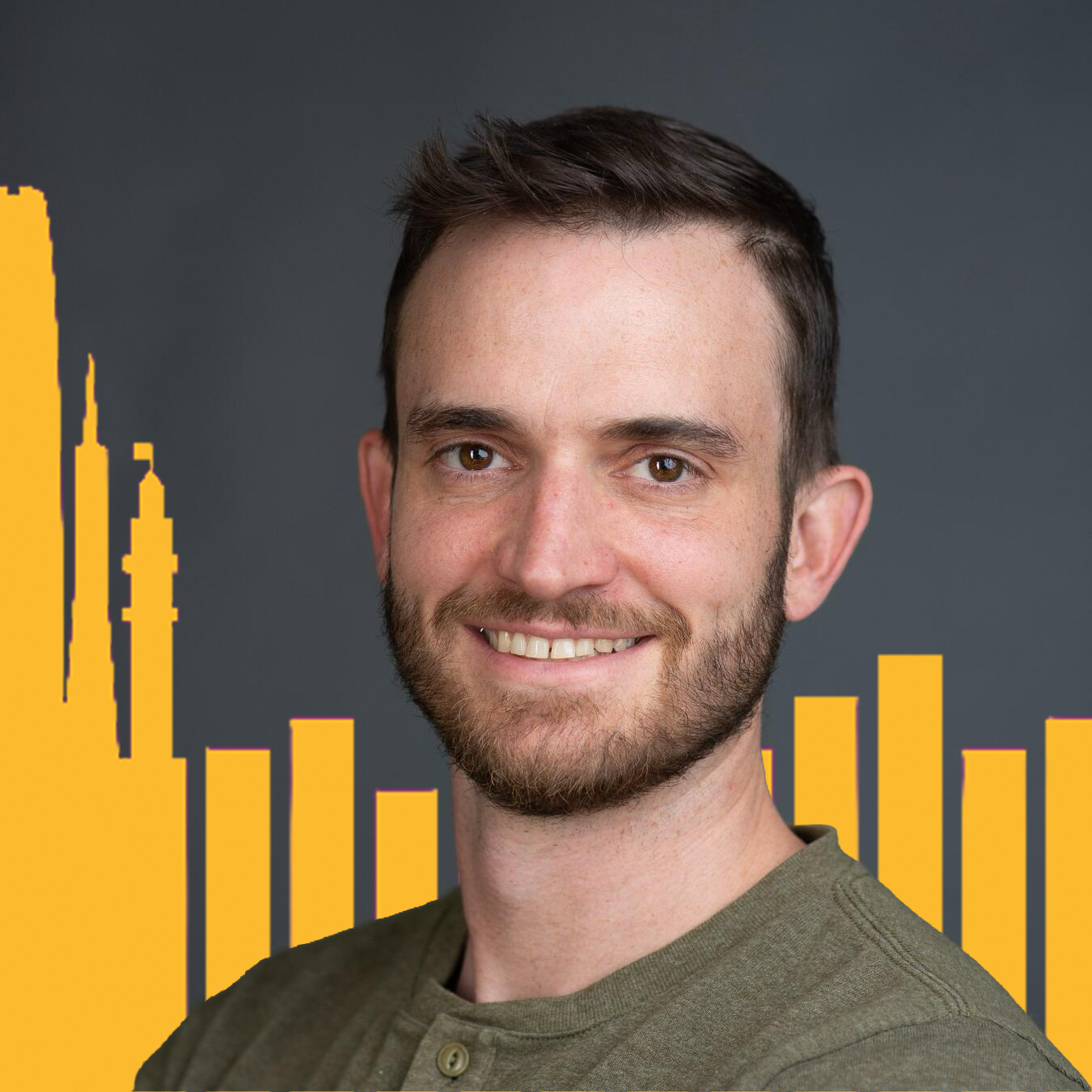 Headshot of Andrew Hobbs with yellow buildings in the background