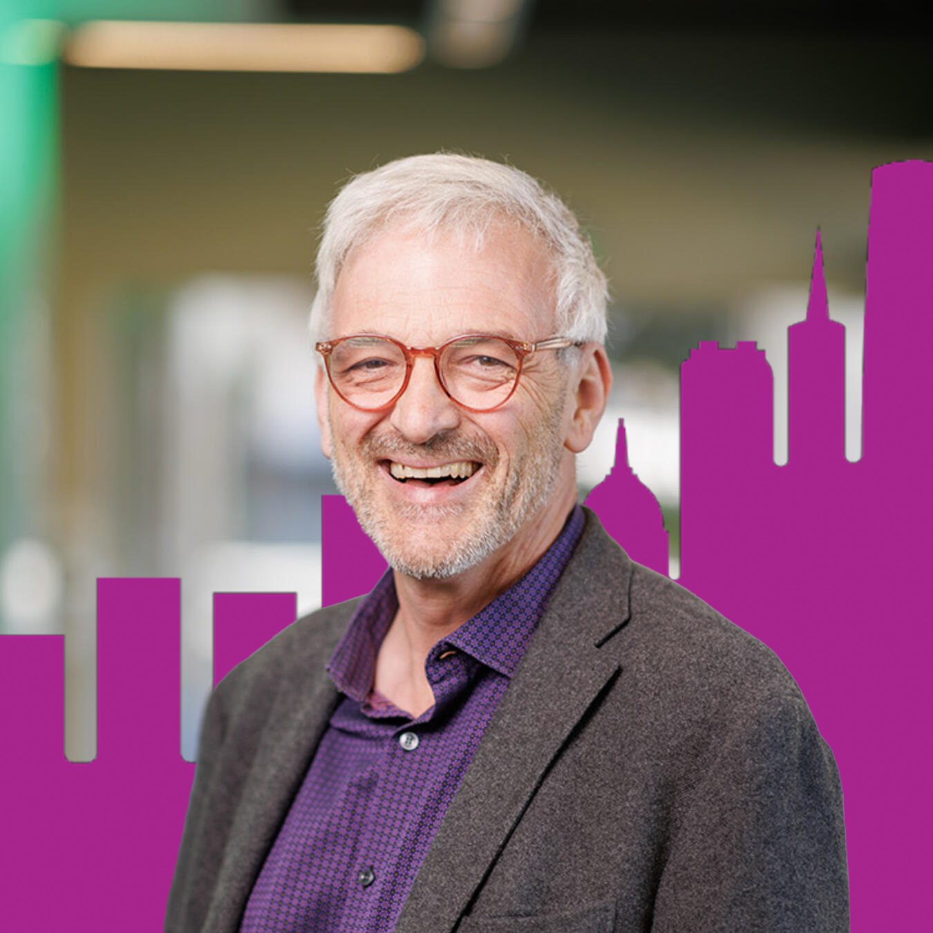Headshot of John Zarobell with purple buildings in the background
