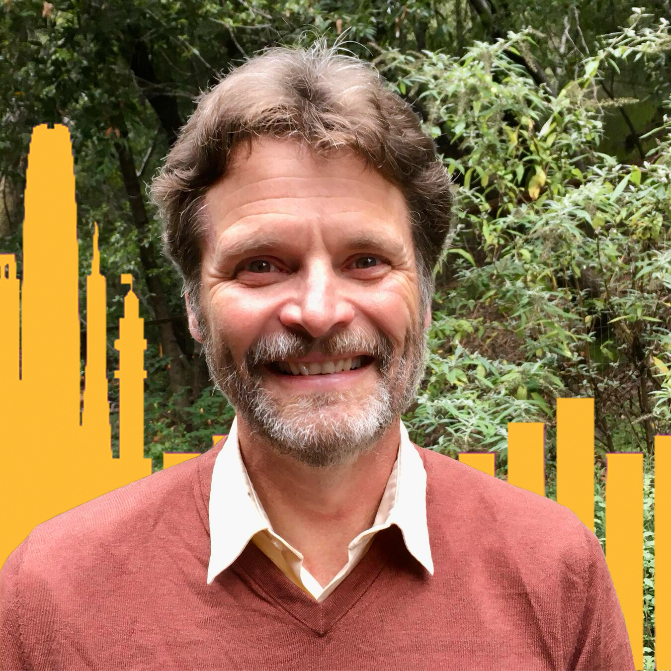 Headshot of Patrick Murphy with trees in the background and yellow buildings