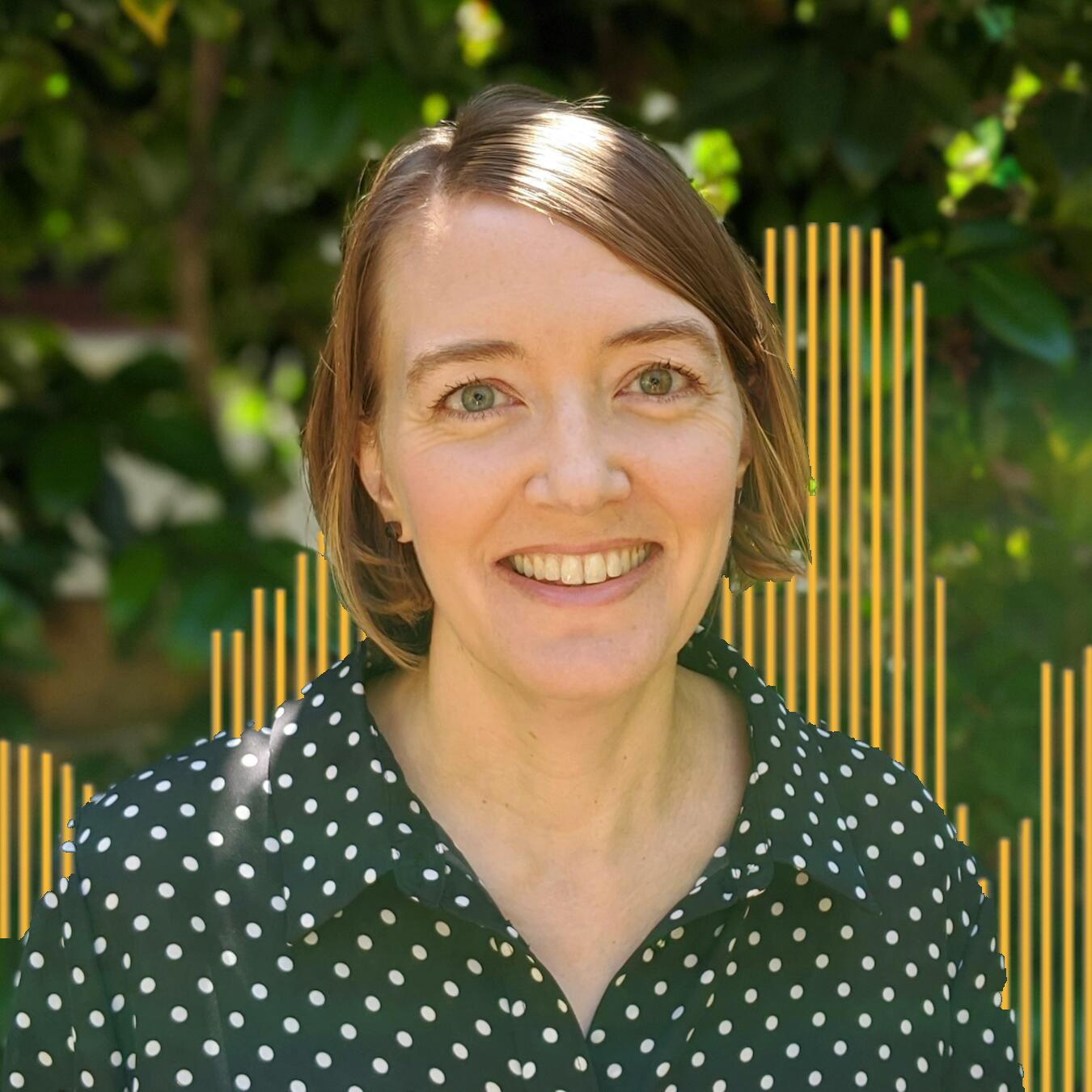 Headshot of Rachel Beth Egenhoefer with green leaves and yellow lined buildings in the background