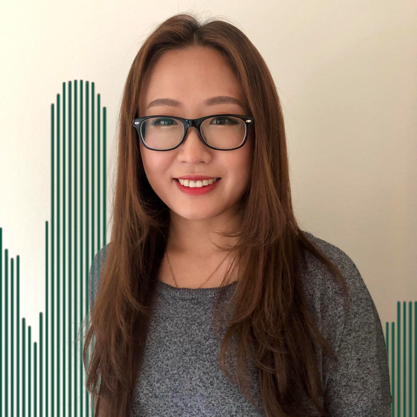 Headshot of Shan Wang with green lined buildings in the background