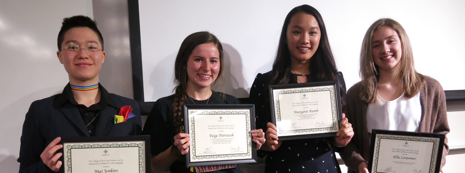 students holding awards