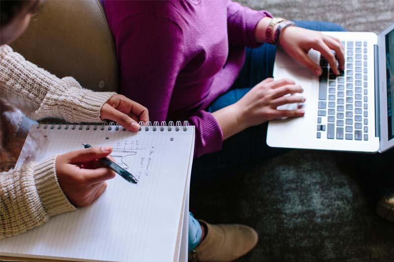 Two students working on schoolwork