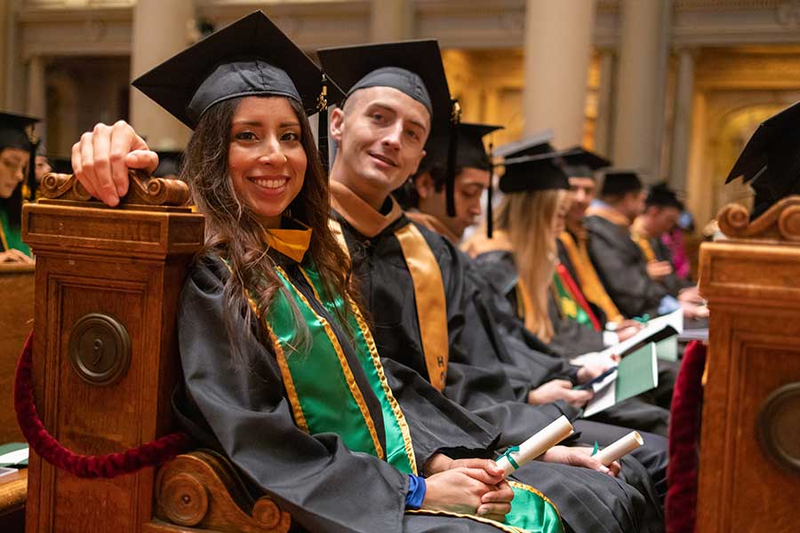 Students sitting in a pew at commencement