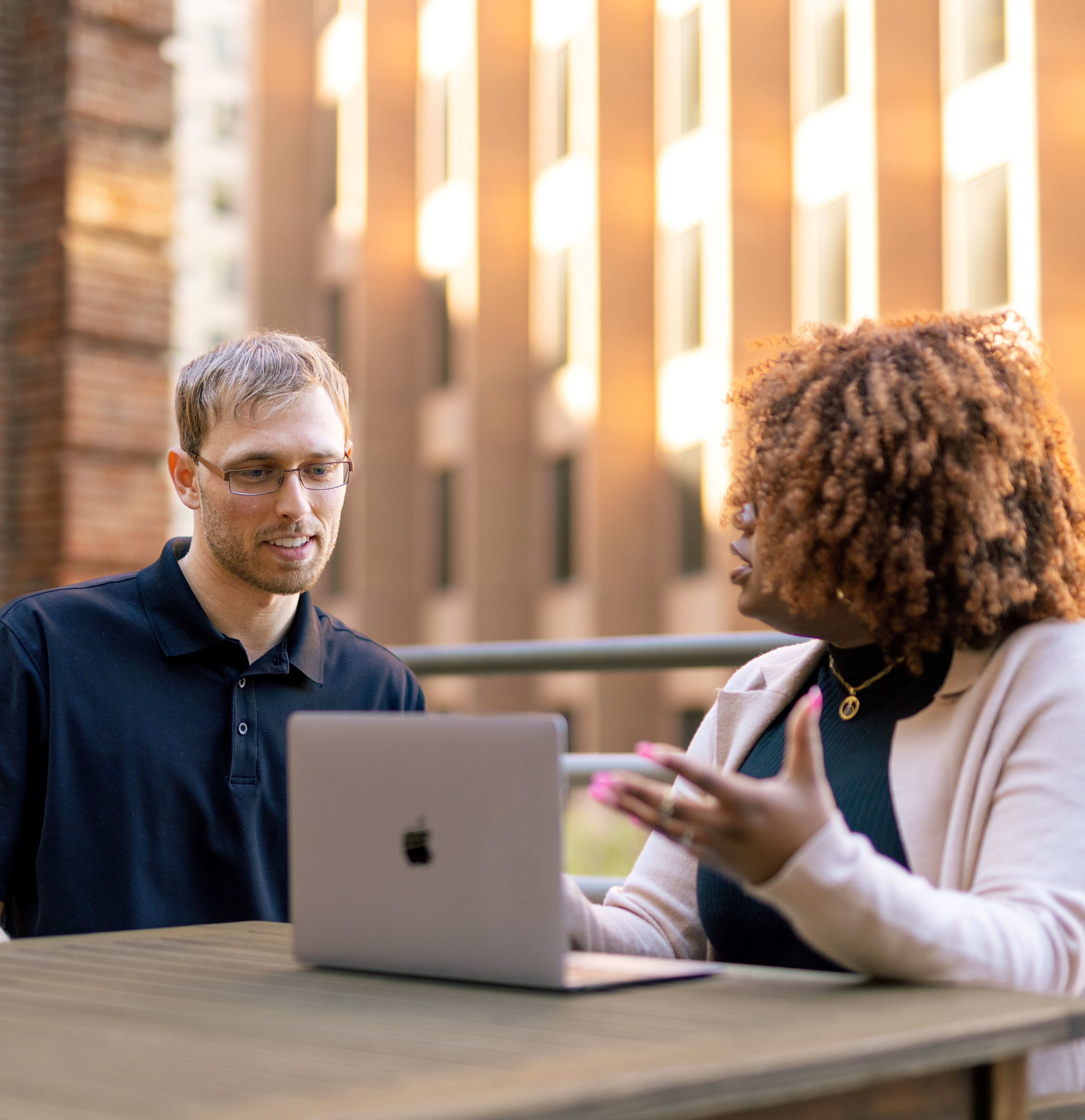 woman and man looking at computer