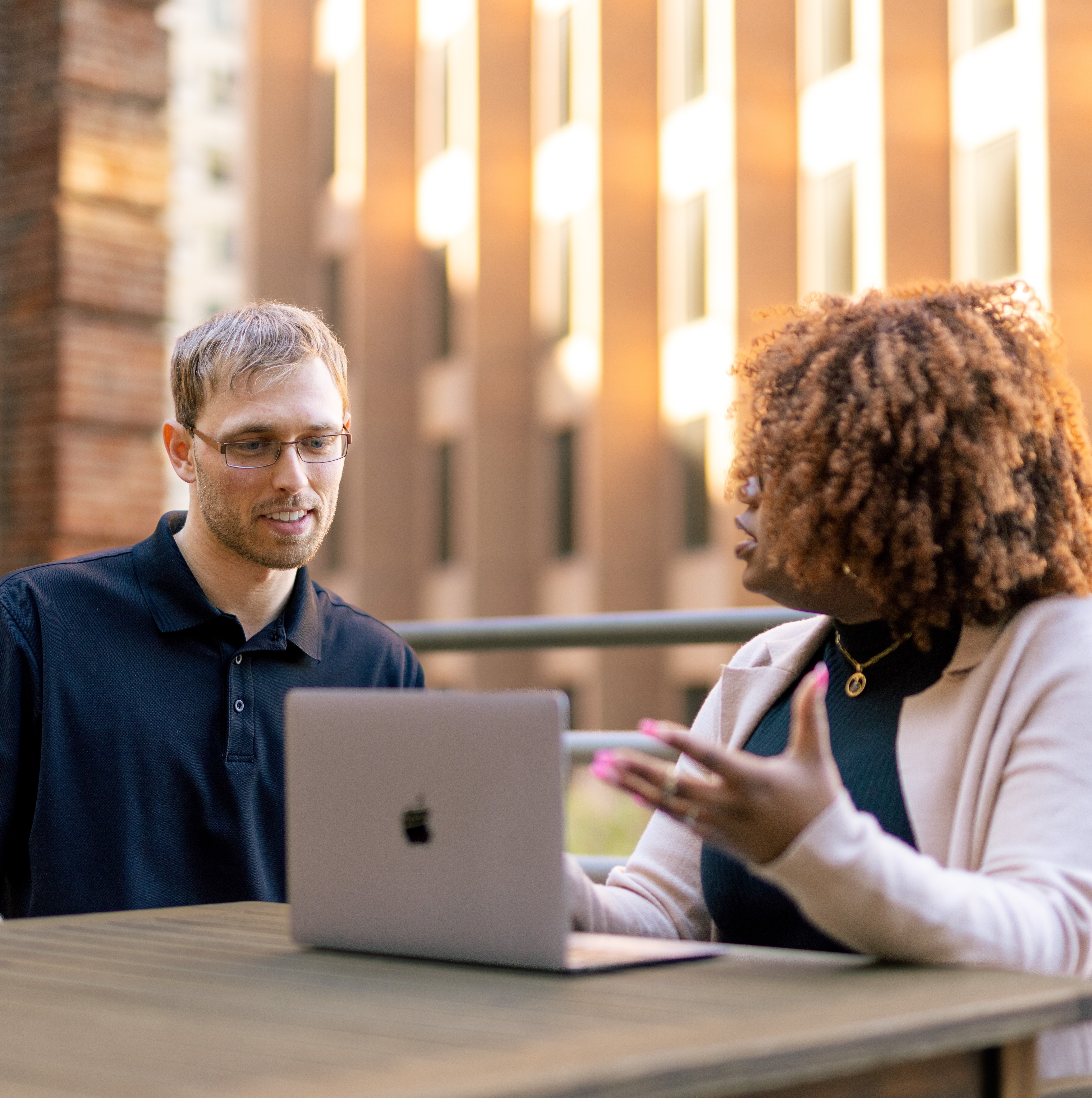 man and woman looking at computer