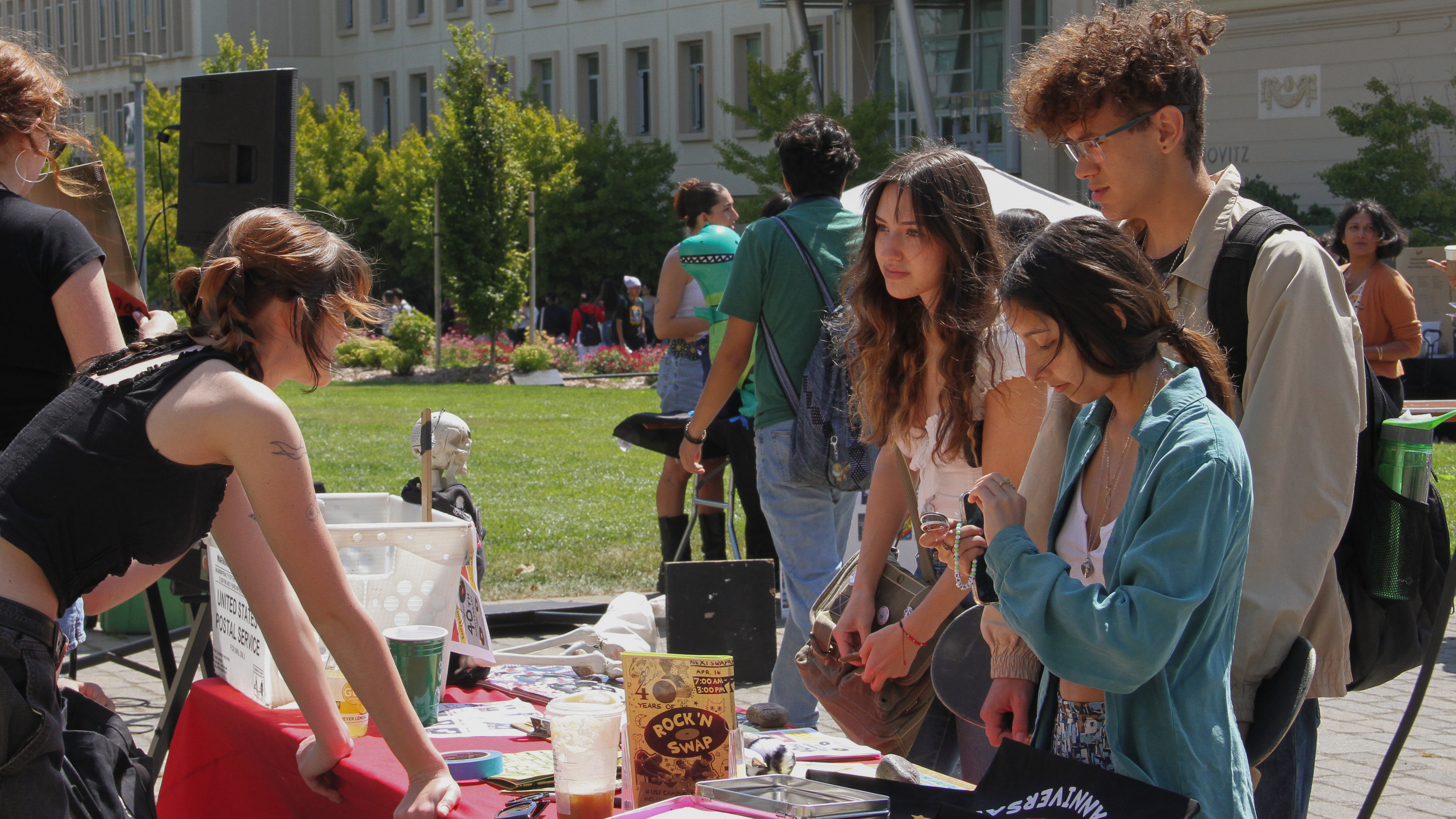 three students at an organization's table 