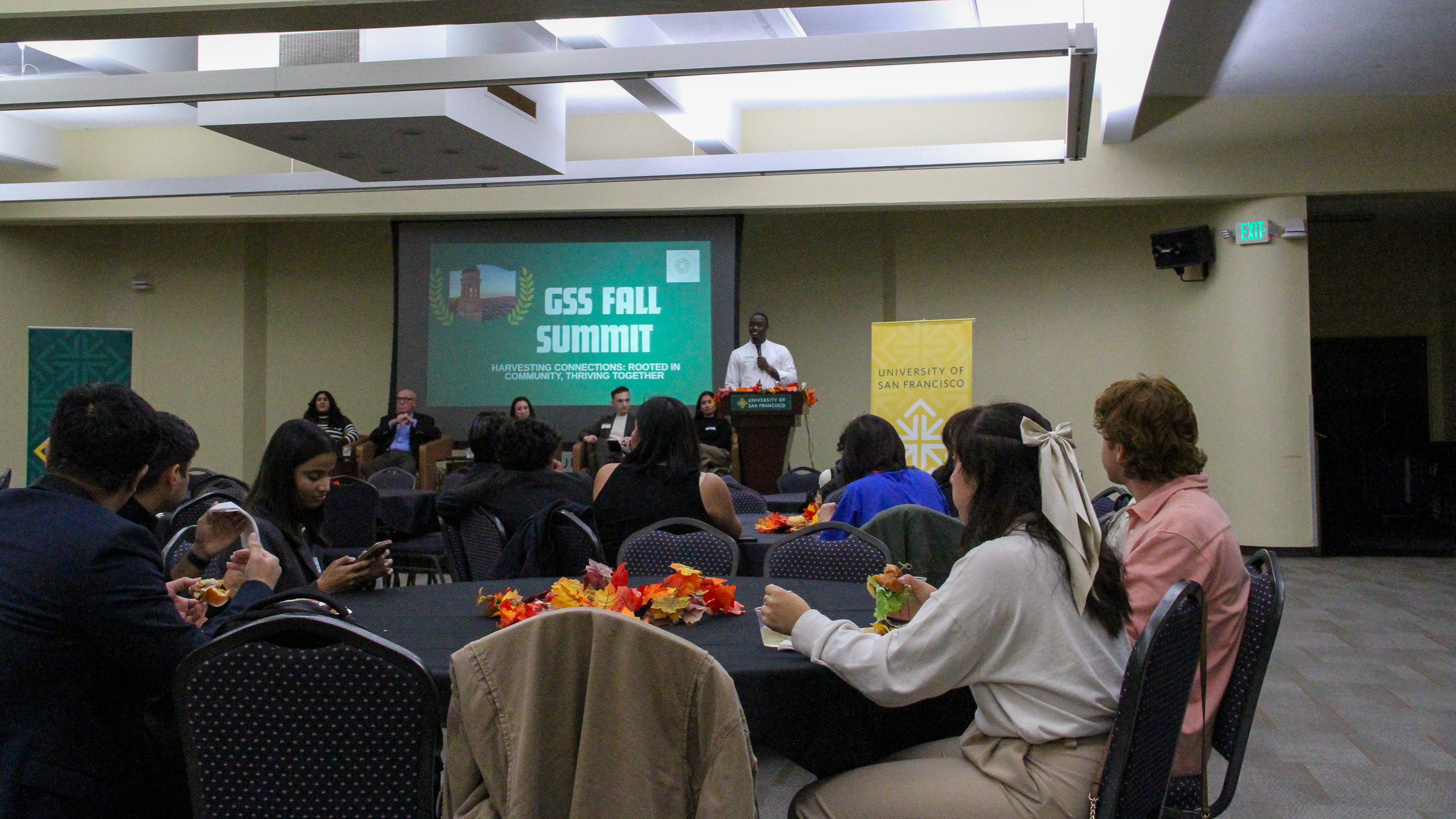 Photo of students sitting at round tables during fall summit.