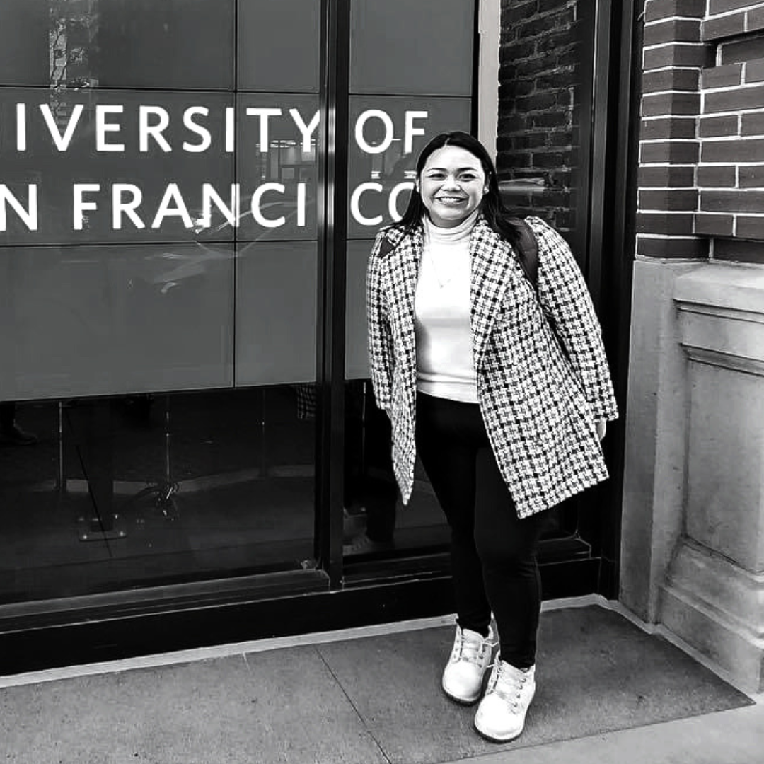 Barnadine in a black and white photo standing in front of USF sign