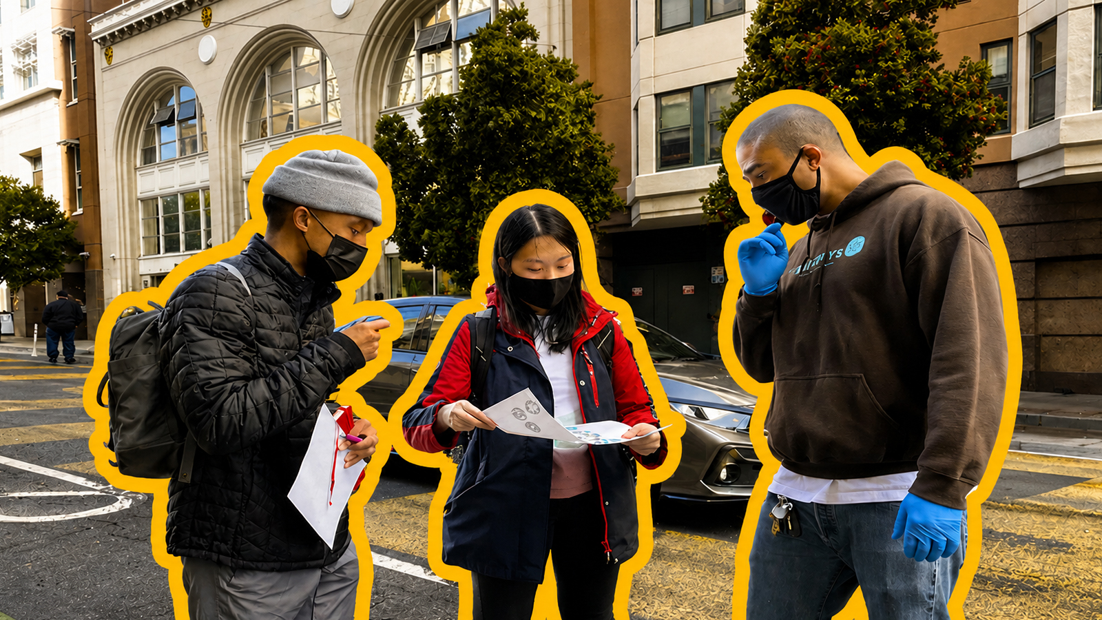 Three members of a non profit organization standing together at a city intersection, reviewing printed papers. They wear jackets and face masks, suggesting an outdoor or public setting. One person holds documents while the others lean in to read, with buildings, parked cars, and a crosswalk visible in the background, indicating collaboration in a real-world community environment.