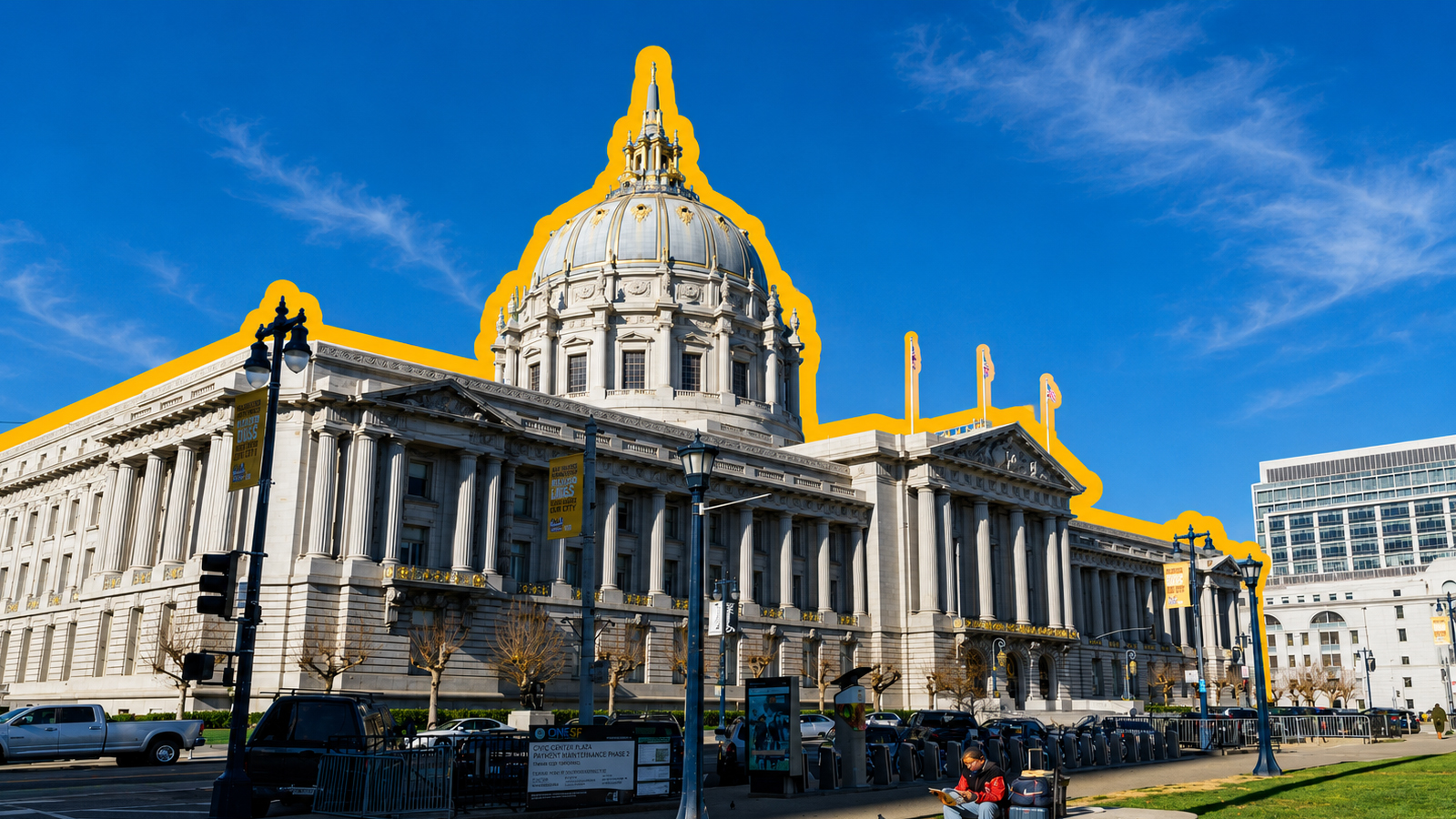 Wide-angle view of San Francisco City Hall, a large neoclassical building with a prominent dome, columns, and ornate architectural details. The building is outlined with a graphic highlight against a bright blue sky, with a street, fencing, and surrounding urban elements visible in the foreground.