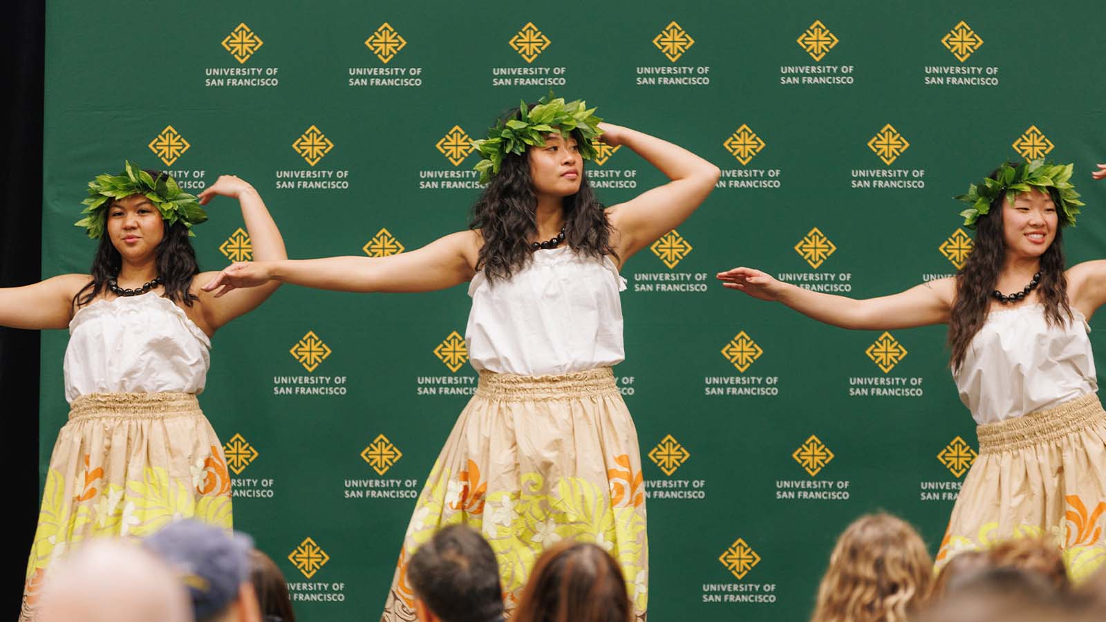 Three students dancing on stage