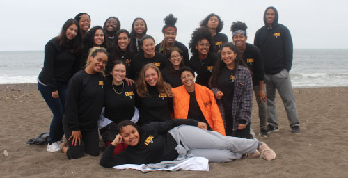 students at the beach on the sand