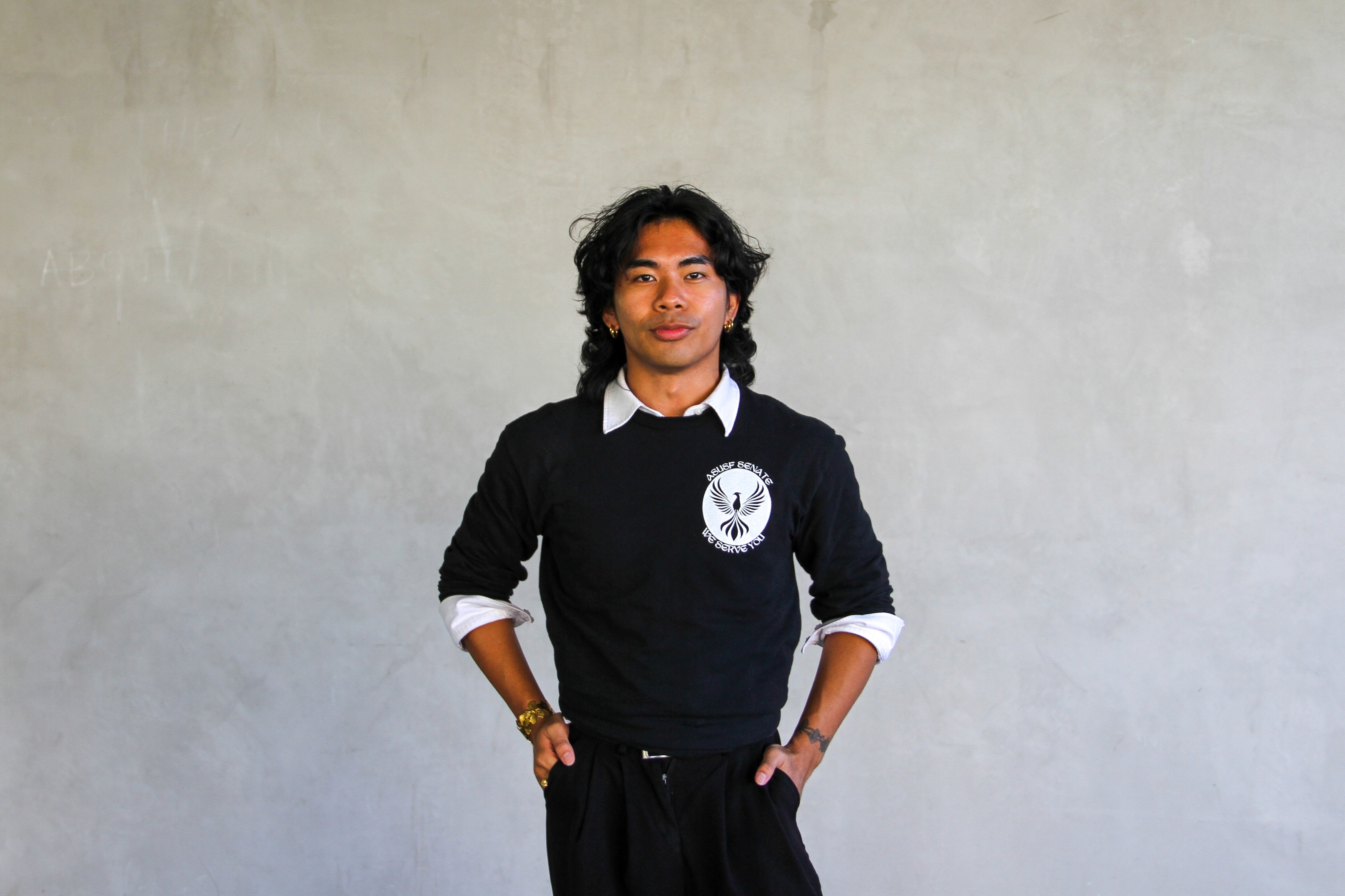 Image of Mar Ruiz, President of ASUSF Senate, smiling and standing with hands pocket