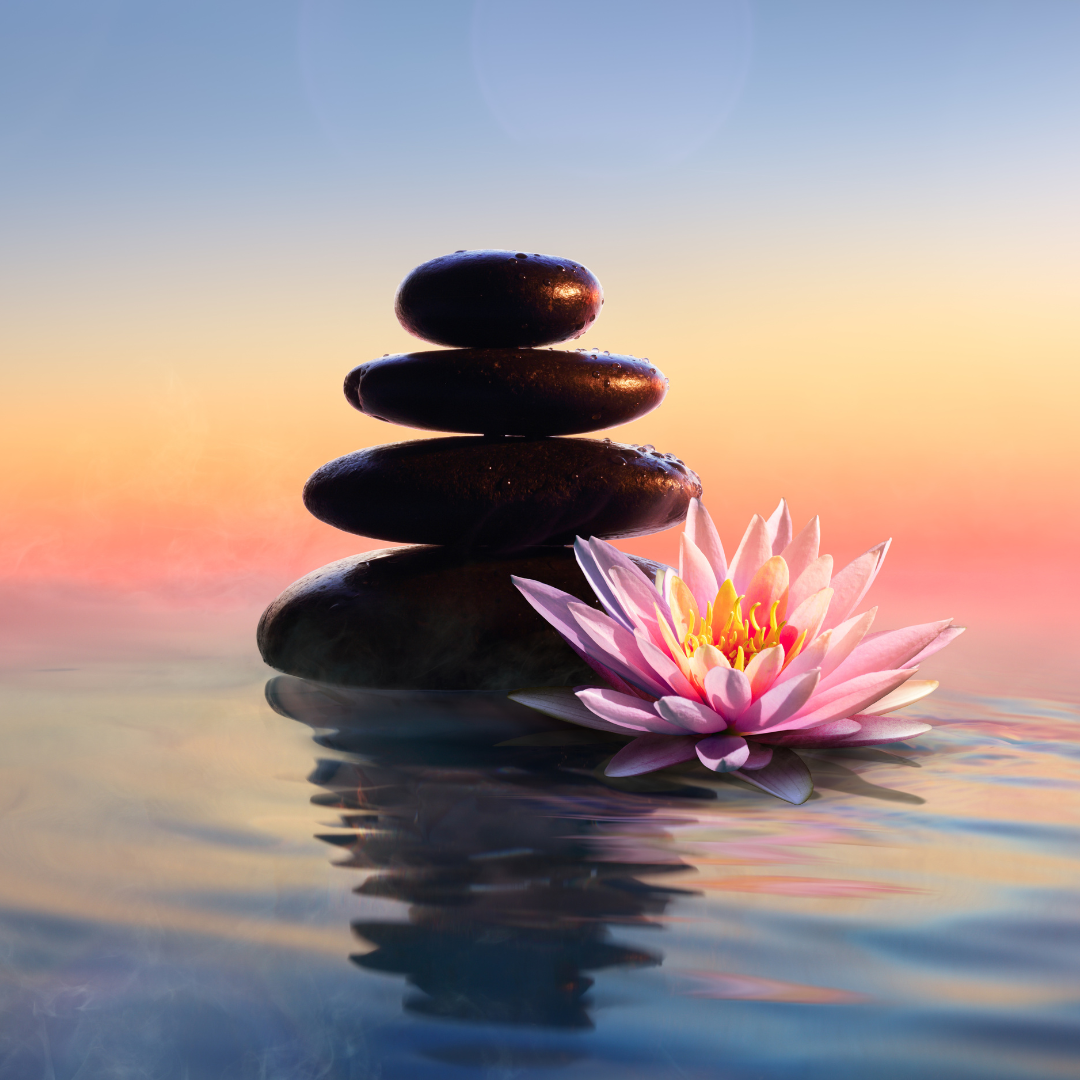 Rock sculpture and flower on tranquil water