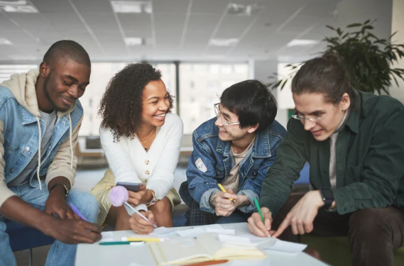 A group of students sitting at a table studying.