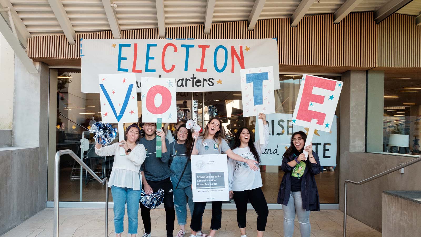 Students holding voting signs