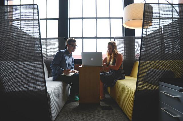 people sitting around a computer