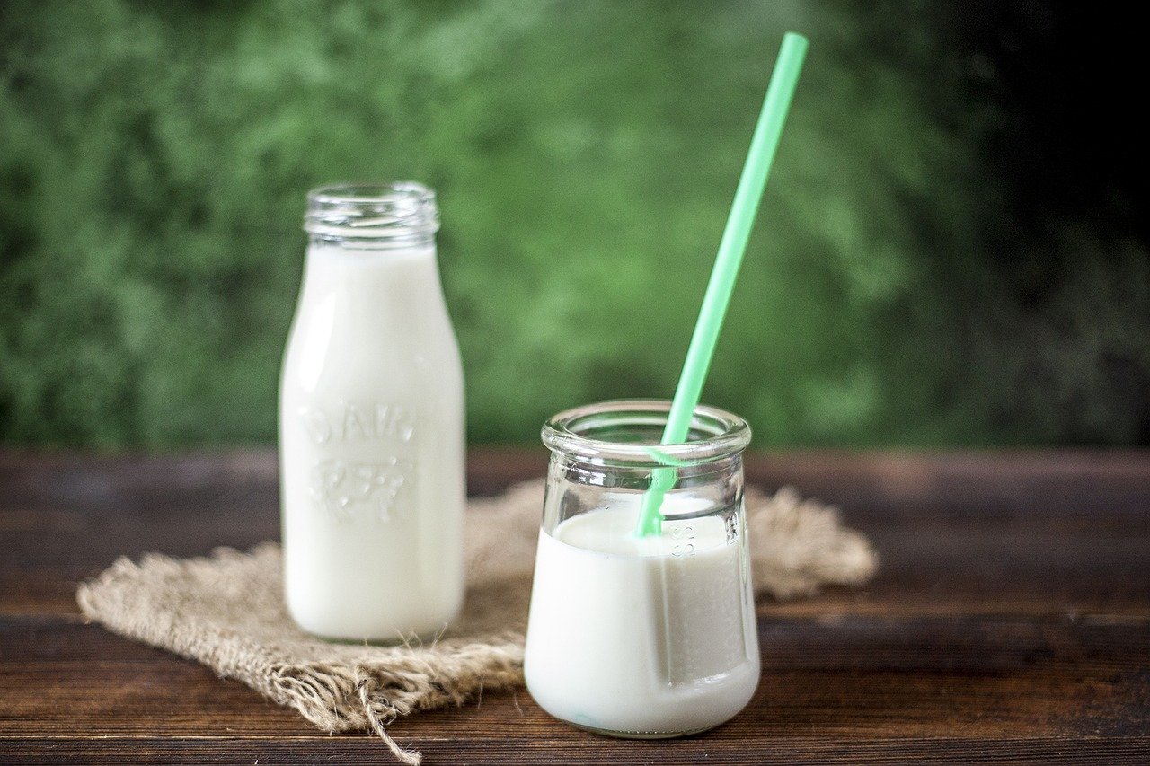 Milk bottles with one bottle with a straw