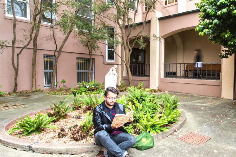 student reading in the school of education courtyard