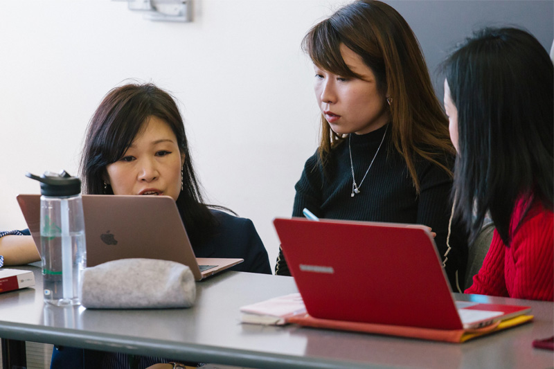 faculty helping a student in the classroom