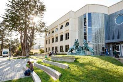 Gleeson Library lawn and wolves sculpture