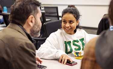 USF student chatting with a peer